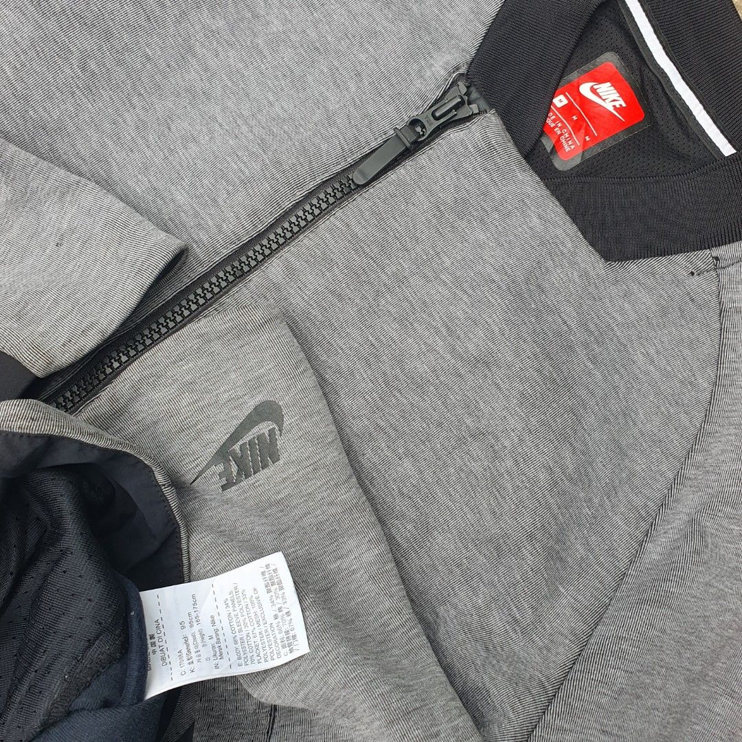 Nike Tech Full Zip Bomber Jacket Grey Medium (Category: Coats, Jackets and Outerwear) located in Cavite. Submitted by josephnl (Listing ID 1466131491, Image 2). Description: - Brand: Nike Tech - Color: Grey - Size: Medium (Approx. 20" chest, 26" length) - Details: Full zip, side zippered pockets, ribbed collar - Authenticity: Includes inner tag and care label.