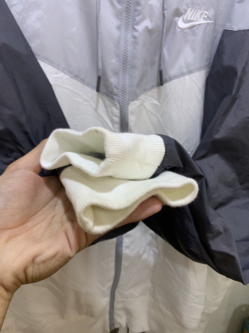 Nike Tri Tone (Category: Coats, Jackets and Outerwear) located in Virac. Submitted by tbn_thrift_shop (Listing ID 1466103946, Image 2). Description: - Authentic Nike windrunner jacket - Colorway: Grey, white, and dark grey - Full zip front with matching drawstring hood - Embroidered Nike logo on the chest - Ribbed cuffs and hem to keep the wind out - Lightweight hybrid build: 100% polyester (lower body/mesh) and 100% nylon (upper body/sleeves) - 