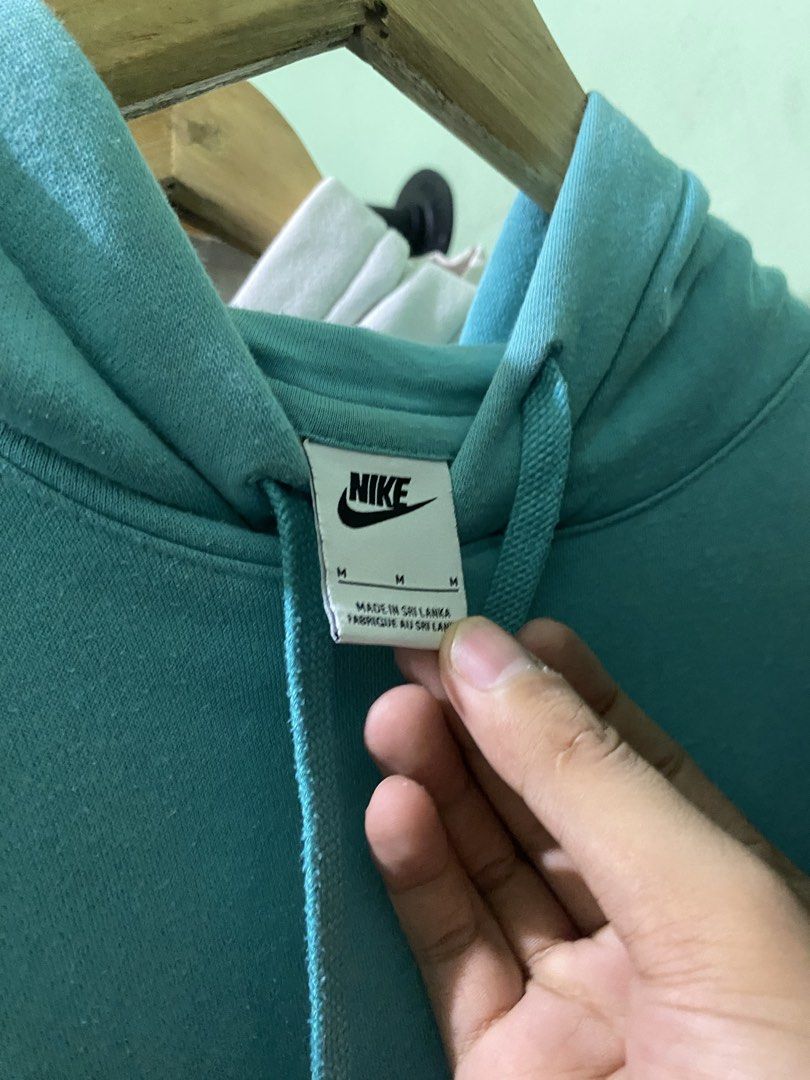 Nike Turquoise Blue Hoodie (Category: Coats, Jackets and Outerwear) located in Tiaong. Submitted by maticbuy (Listing ID 1465965852, Image 2). Description: - Brand: Nike - Style: Classic pullover hoodie with adjustable drawstring hood and front kangaroo pocket - Color: Bright turquoise blue - Size: Medium (M) - Branding: Small embroidered white Nike Swoosh logo on the left chest - Details: Made in Sri Lanka with clean inner tags (Style code: BV28