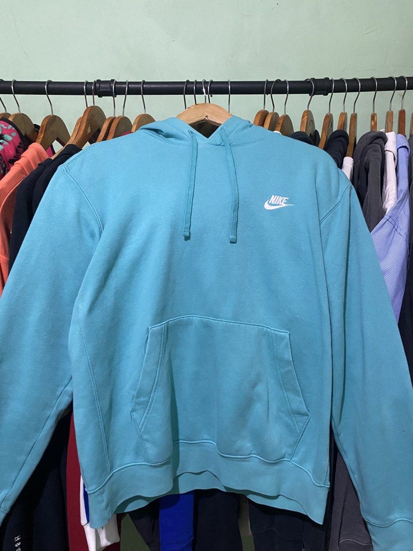 Nike Turquoise Blue Hoodie (Category: Coats, Jackets and Outerwear) located in Tiaong. Submitted by maticbuy (Listing ID 1465965852, Image 1). Description: - Brand: Nike - Style: Classic pullover hoodie with adjustable drawstring hood and front kangaroo pocket - Color: Bright turquoise blue - Size: Medium (M) - Branding: Small embroidered white Nike Swoosh logo on the left chest - Details: Made in Sri Lanka with clean inner tags (Style code: BV28
