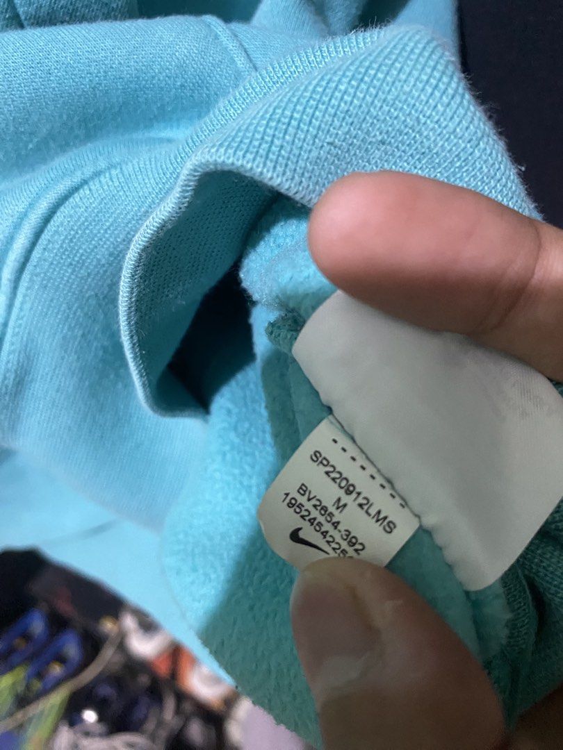Nike Turquoise Blue Hoodie (Category: Coats, Jackets and Outerwear) located in Tiaong. Submitted by maticbuy (Listing ID 1465965852, Image 3). Description: - Brand: Nike - Style: Classic pullover hoodie with adjustable drawstring hood and front kangaroo pocket - Color: Bright turquoise blue - Size: Medium (M) - Branding: Small embroidered white Nike Swoosh logo on the left chest - Details: Made in Sri Lanka with clean inner tags (Style code: BV28