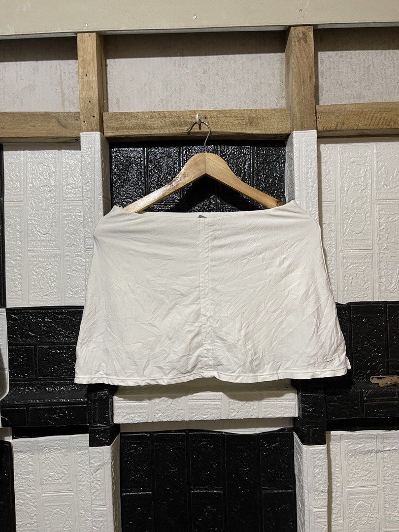 Nike White Tennis Skort (Category: Activewear) located in Lopez. Submitted by thrift.ni.roms22 (Listing ID 1466151264, Image 1). Description: - Color: White - Style: Classic pleated tennis skort with built-in shorts underneath - Details: Small embroidered Nike swoosh logo near the hem and special Nike tennis court label inside - Material: Lightweight fabric - Condition: Great for sports, tennis matches, or active days out.