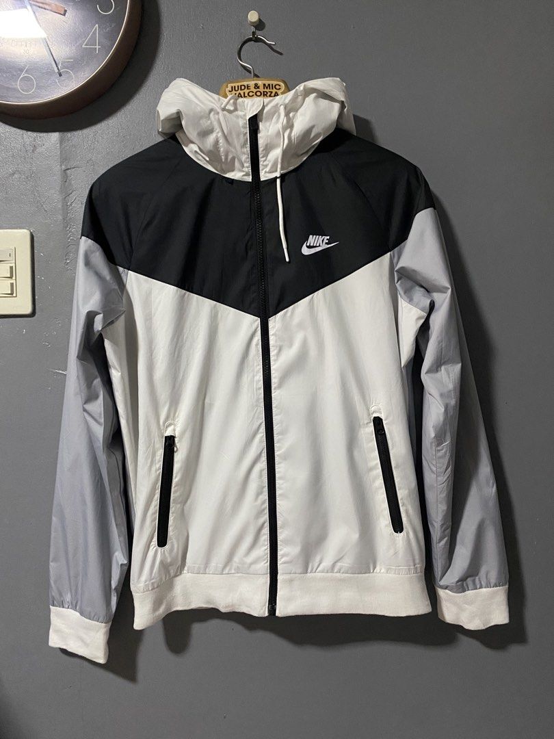 Nike Windrunner Jacket White Black Grey Size S (Category: Coats, Jackets and Outerwear) located in Tanay. Submitted by judevalcorza (Listing ID 1466040554, Image 1). Description: - Brand: Nike - Style: Windrunner jacket - Colorway: White, black, and grey - Size: S (Tag on collar) - Measurements: 26 inches length, 21 inches chest (pit-to-pit) - Material: 100% polyester with breathable mesh interior lining - Origin: Made in Vietnam - Features: Full