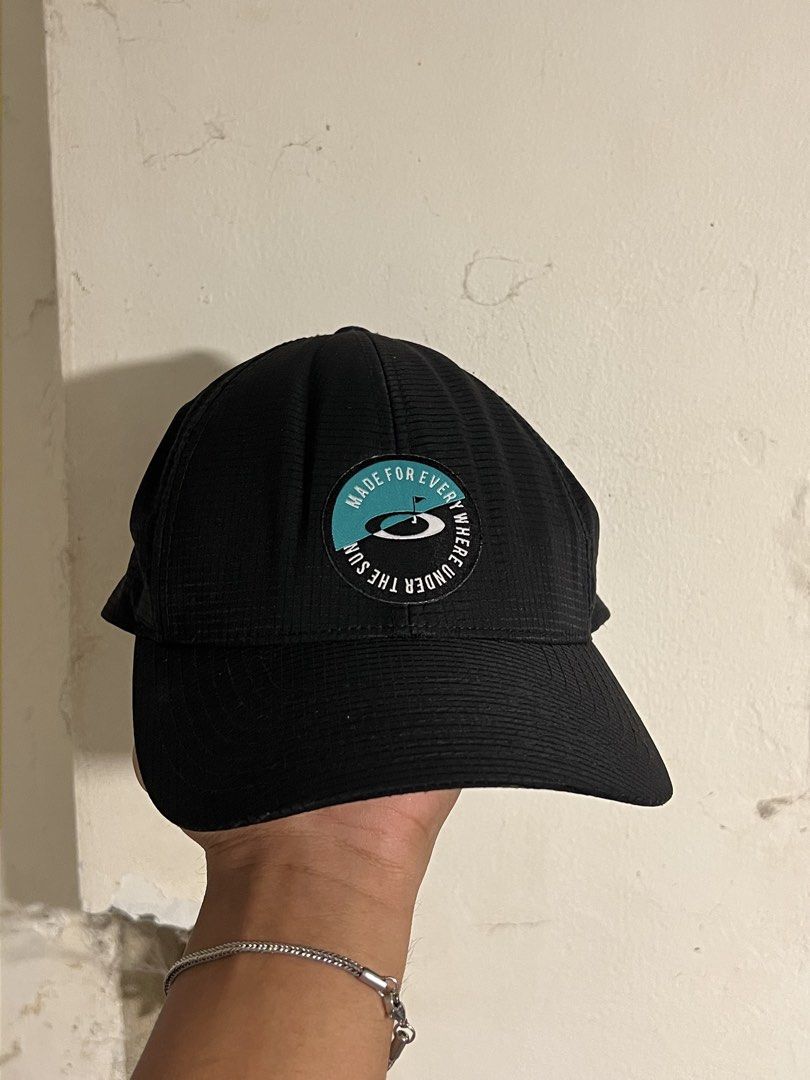 Oakley Made For Everywhere Black Cap (Category: Caps & Hats) located in Manila. Submitted by maccabeyo (Listing ID 1466045895, Image 1). Description: - Color: Classic Black - Material: Textured grid fabric for a modern look - Design: Round embroidered patch with Oakley logo and "Made For Everywhere Under The Sun" text - Fit: Adjustable strap closure in the back with a small branded tab - Origin: Made in Vietnam (Since 1975) - Condition: Brand new