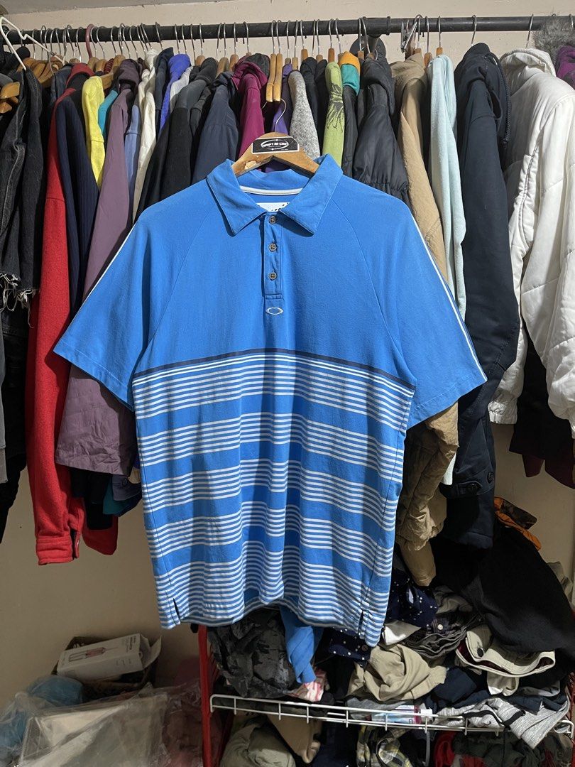 Oakley Poloshirt (Category: Activewear) located in Cabuyao City. Submitted by jeirussamson897 (Listing ID 1466046966, Image 1). Description: Oakley Poloshirt medium 22 width 29 length stretchable excelelnt condition has sign of ussage needwash ob neckline hairline on bottom prints cut washtag 9/10 649+sf.