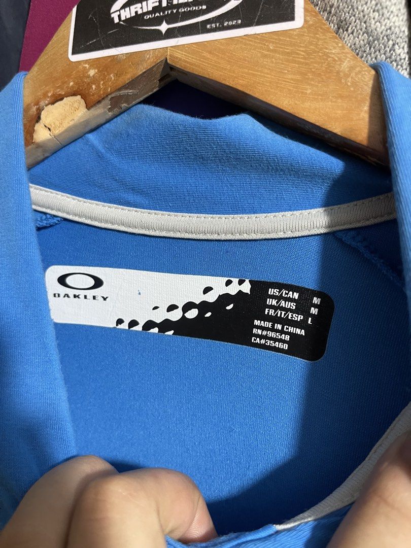 Oakley Poloshirt (Category: Activewear) located in Cabuyao City. Submitted by jeirussamson897 (Listing ID 1466046966, Image 3). Description: Oakley Poloshirt medium 22 width 29 length stretchable excelelnt condition has sign of ussage needwash ob neckline hairline on bottom prints cut washtag 9/10 649+sf.