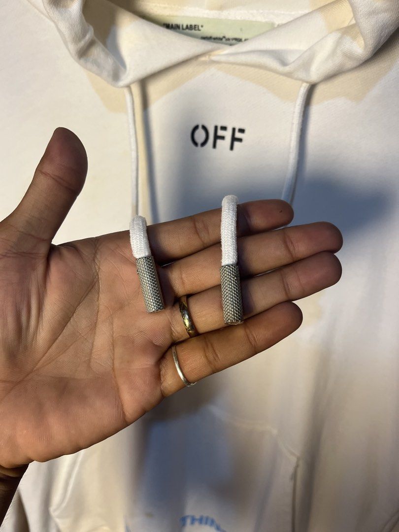 Off-White Seeing Things White Hoodie (Category: Hoodies) located in Kidapawan. Submitted by azythrift (Listing ID 1466050156, Image 3). Description: - Brand: Off-White - Color: White - Design: 'OFF' text on chest, 'SEEING THINGS' print on sleeve and near pocket - Details: Long drawstrings with metal aglets - Size: 22x26 (Measurements on hanger tag) - Condition: Flawed - yellowish staining visible around collar, chest, and bottom pocket area - PM 