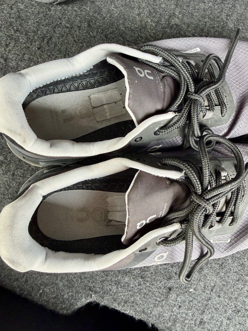 On Cloud Waterproof Sneakers (Category: Sneakers) located in Manila. Submitted by miggy069 (Listing ID 1465984155, Image 2). Description: - Brand: On Cloud - Color: Grey and Black - Type: Waterproof running shoes - Features: Lace-up closure, signature branding, textured mesh upper, chunky cushioned soles - Condition: Insoles show some wear and peeling marks from previous use - Best for: Daily walking, running, or rainy days.