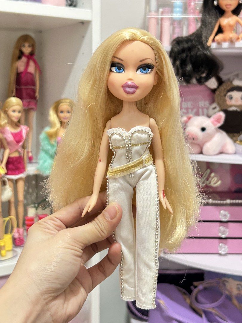 ON SALE Bratz “Designed by” Chloe (Category: Kids Toys) located in Batangas. Submitted by nommi26 (Listing ID 1466145819, Image 1). Description: WYSIWYG - OG/ Authentic Bratz "Designed by" Chloe fashion doll - Striking long blonde hair and vibrant blue eyes - Dressed in her OG chic white and gold jumpsuit accented with stylish beadwork & attached belt - Condition: 7/10 with minor signs of play/wear (small marks on arms visible in photos, also som