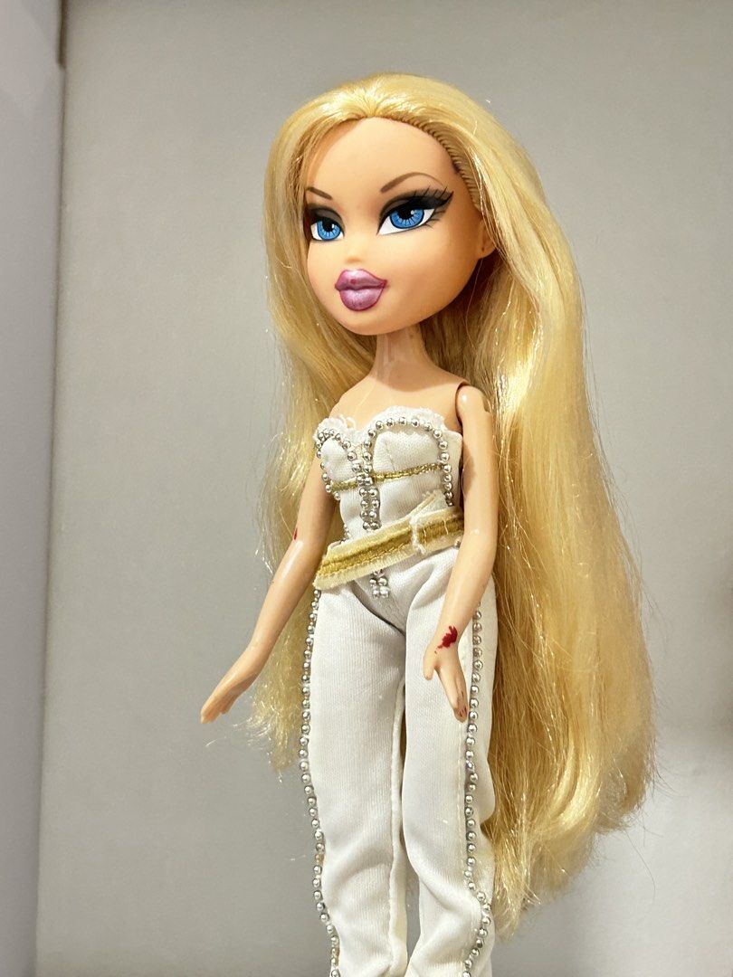 ON SALE Bratz “Designed by” Chloe (Category: Kids Toys) located in Batangas. Submitted by nommi26 (Listing ID 1466145819, Image 3). Description: WYSIWYG - OG/ Authentic Bratz "Designed by" Chloe fashion doll - Striking long blonde hair and vibrant blue eyes - Dressed in her OG chic white and gold jumpsuit accented with stylish beadwork & attached belt - Condition: 7/10 with minor signs of play/wear (small marks on arms visible in photos, also som