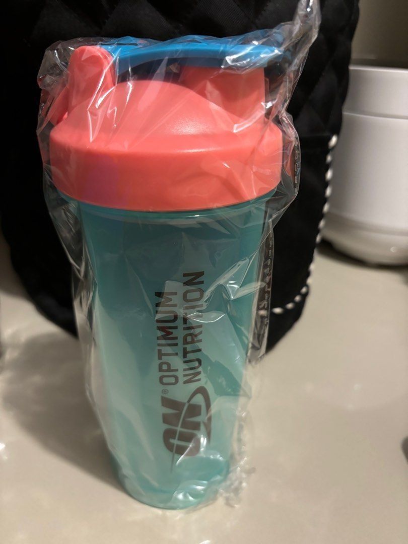 ON Shaker Bottle (Category: Water Bottles & Tumblers) located in Quezon City. Submitted by garagesale2026 (Listing ID 1466132896, Image 2). Description: - Brand new - Still in original plastic packaging - Features a teal body with a coral lid and a blue flip-top.