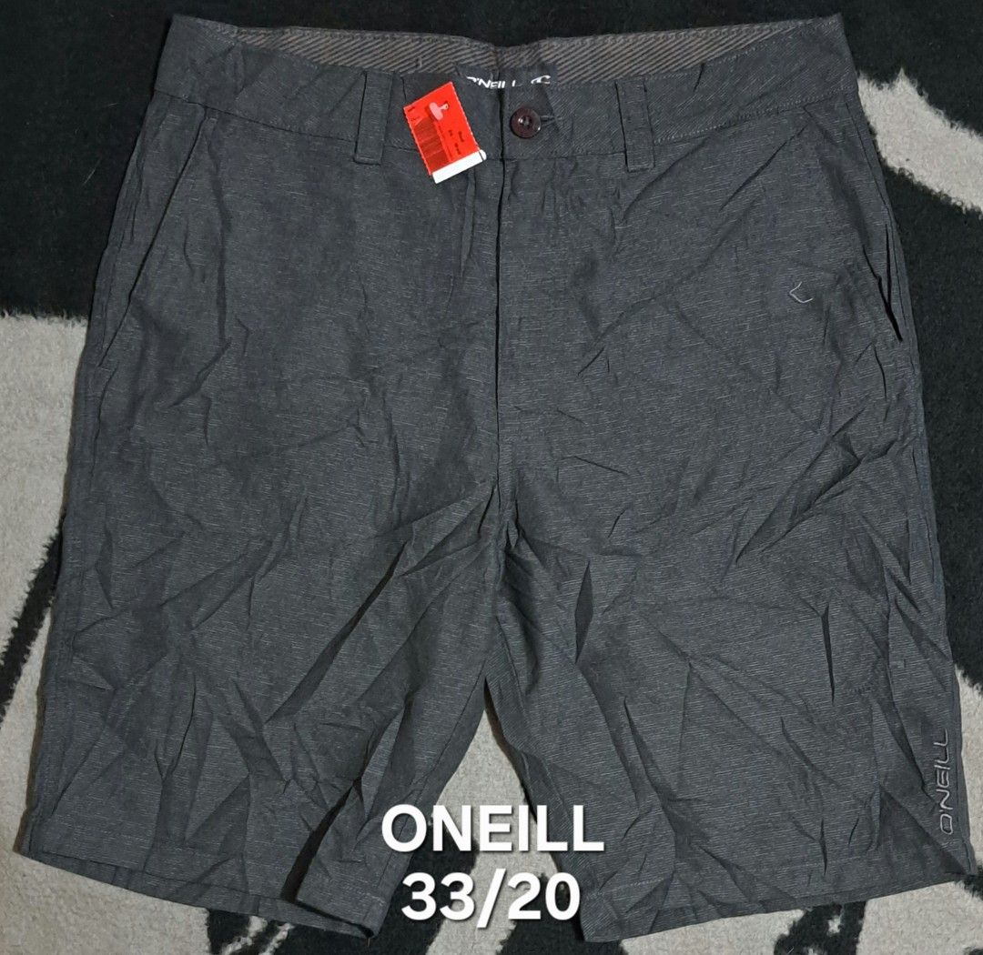 O'Neill Grey Shorts Size 31 (Category: Shorts) located in San Fernando, Camarines Sur. Submitted by ladderaya (Listing ID 1466018647, Image 1). Description: - Brand: O'Neill - Style: Hybrid shorts - Color: Dark grey with subtle textured stripe pattern - Size: 31 - Condition: Brand new with tags attached - Features: Button closure, zip fly, belt loops, and back pocket with button hole detail and label patch - Material: Lightweight.