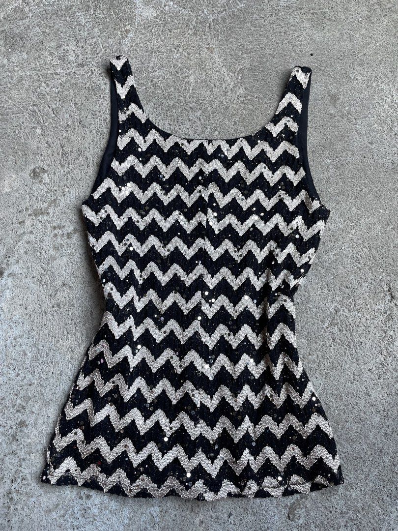 Onyx Nite Black and Silver Sequin Tank Top Medium (Category: Sleeveless) located in Siniloan. Submitted by rethr1ft (Listing ID 1466055903, Image 2). Description: - Brand: Onyx Nite - Style: Sleeveless scoop neck top with black trim - Design: All-over black and silver chevron zigzag pattern with sparkling sequins - Size: Medium (tag attached) - Material: 53% nylon, 40% polyester, 5% metallic, 2% spandex - Origin: Made in USA - Care: Hand wash col