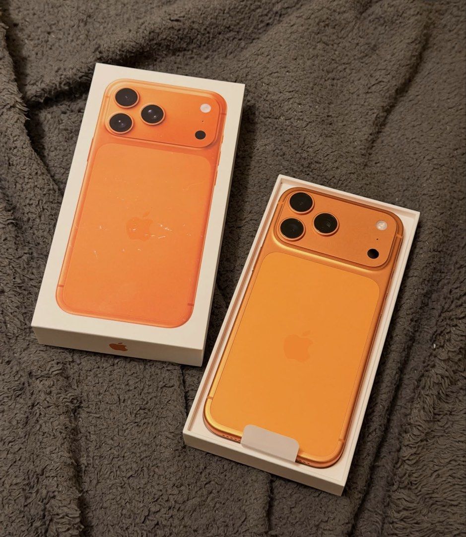 Orange Apple iPhone (Category: iPhone 17 Series) located in Manila. Submitted by trustedseller1902 (Listing ID 1465999636, Image 1). Description: - Model/Color: Bright orange body with matching camera bump and iconic Apple logo - Camera: Advanced triple-lens setup - Design: Modern flat edges with responsive volume and power buttons - Inclusions: Comes with the original box, charging cable, and SIM ejector tool - Condition: Excellent, ready for a 