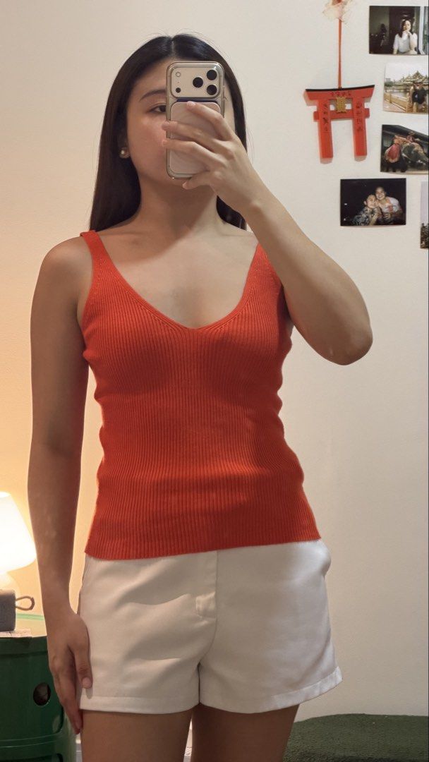 Orange ribbed V-neck tank top (Category: Sleeveless) located in Cebu City. Submitted by wearhousebyhya (Listing ID 1466021220, Image 2). Description: - Color: Bright orange - Material: Stretchy ribbed knit, very comfortable - Design: Deep V-neckline with thick straps - Fit: Fitted silhouette through the torso - Condition: Worn once, washed and ready to wear.