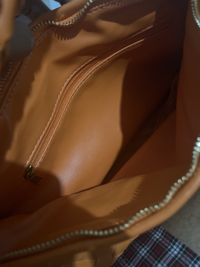 Orange Woven Shoulder Bag with Knot Handle (Category: Shoulder Bags) located in Las Pinas. Submitted by erenrosc (Listing ID 1466082067, Image 3). Description: - Color/Material: Bright orange woven faux leather - Design: Unique knotted handle on one side - Hardware & Closure: Gold-tone hardware with secure top zip closure - Interior: Spacious matching lining with an extra zippered pocket - Condition: Clean overall, great statement piece for daily