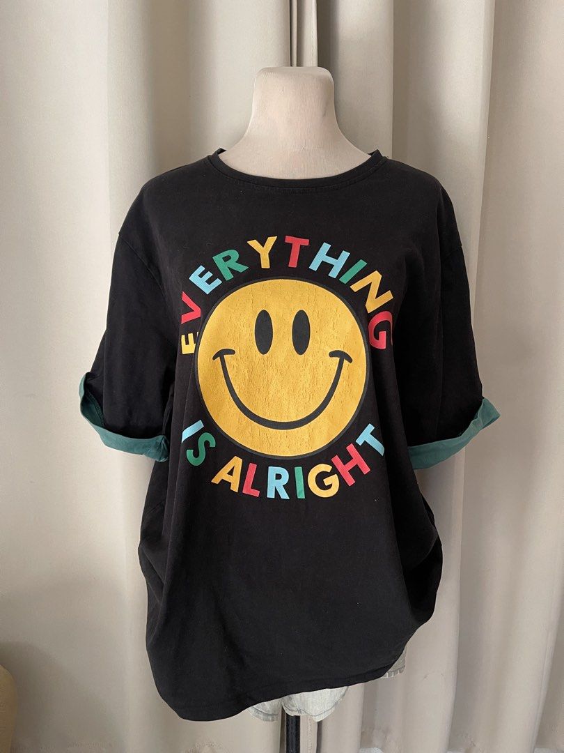 oversized heavy cotton (Category: Shirts) located in Cainta. Submitted by zlove111 (Listing ID 1466109965, Image 1). Description: - Color: Black with dark green contrast cuffs - Design: Large yellow smiley face with multi-colored 'EVERYTHING IS ALRIGHT' lettering - Fit: Relaxed, oversized fit for ultimate comfort - Details: Print features a stylish slight vintage cracking texture - Style: Perfect for casual, streetwear, and everyday wear up to xx