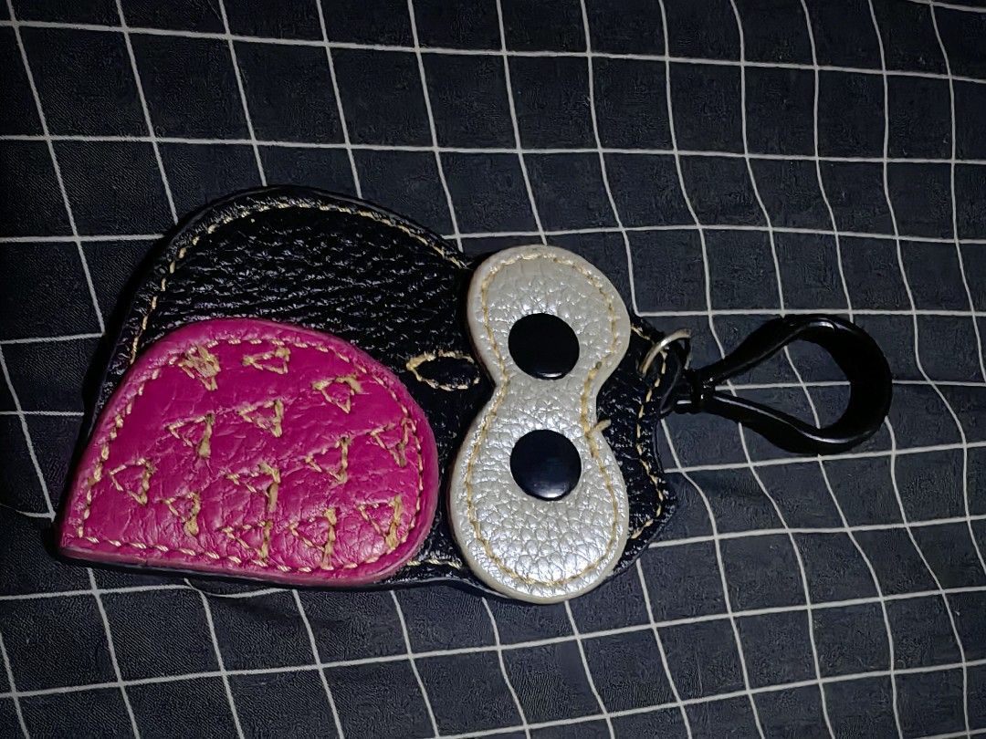 Owl Leather Keychain Bag Charm Black Pink (Category: Charms) located in Davao. Submitted by thefrugalshop (Listing ID 1466087330, Image 1). Description: - Handmade owl shape design in stylish black, pink, and silver leather - Crafted from textured pebble grain leather with striking yellow contrast stitching - Adorable black button eyes on the front - Equipped with a sturdy metal clip for easy hanging on bags, keys, or pouches - Perfect as a gift 