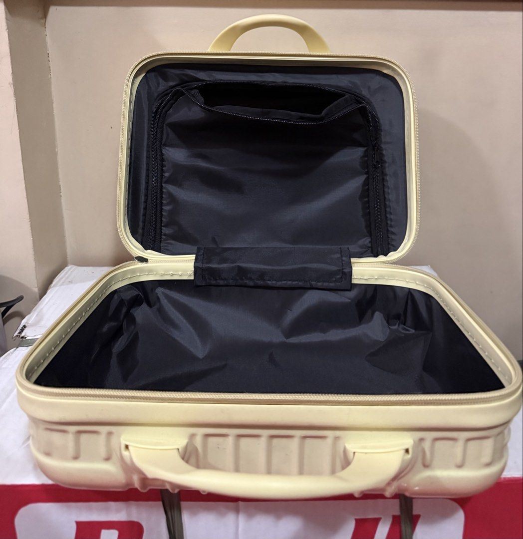 Pale Yellow Hard Shell Cosmetic Vanity Case (Category: Purses & Pouches) located in Imus. Submitted by silentfire-353921 (Listing ID 1465969115, Image 2). Description: - Color: Pale yellow - Material: Hard shell with vertical ribbed exterior - Closure: Zip-around with top carry handle - Interior: Lined with black fabric - Organization: Zippered mesh pocket on upper lid flap and deep main compartment - Condition: Clean and ready for use - Ideal fo