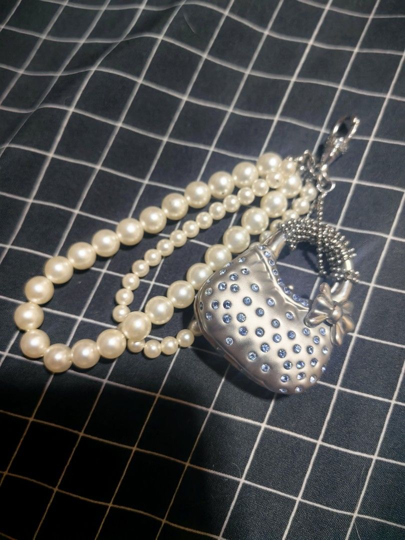 Pearl and Rhinestone Handbag Charm with Strap (Category: Charms) located in Davao. Submitted by thefrugalshop (Listing ID 1466087795, Image 2). Description: - Y2K aesthetic silver mini handbag charm - Covered in sparkly blue rhinestones with a cute side bow accent - Textured handle and multi-strand faux pearl strap in varying bead sizes - Convenient clip hook at the top for bags, keys, or accessories - Brand new and ready to ship!.