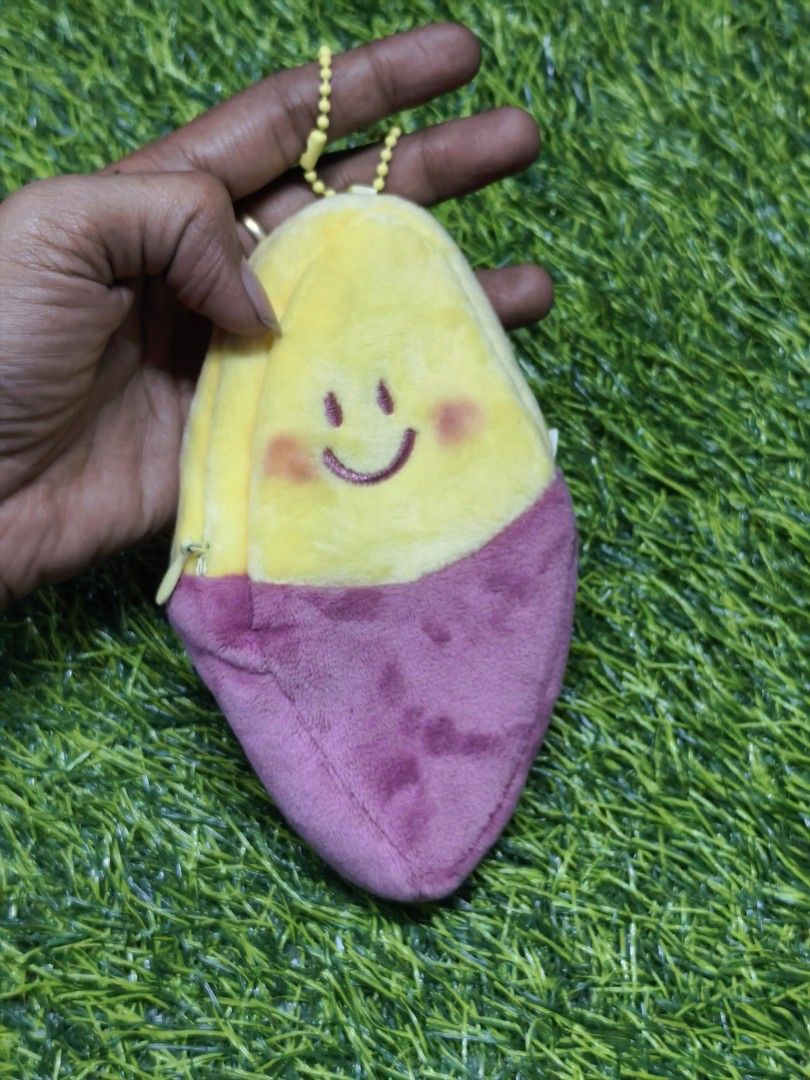 Peripera Sweet Potato Plush Pouch Bag Charm (Category: Plushies & Soft Toys) located in Paranaque City. Submitted by furugiyafinds (Listing ID 1466103314, Image 1). Description: - Authentic Peripera sweet potato plush pouch - Features a cute embroidered smiley face on the yellow top and roasted yam skin design on the purple bottom - Made with ultra-soft material - Equipped with a yellow ball chain for easy hanging on bags or keys - Comes with ori