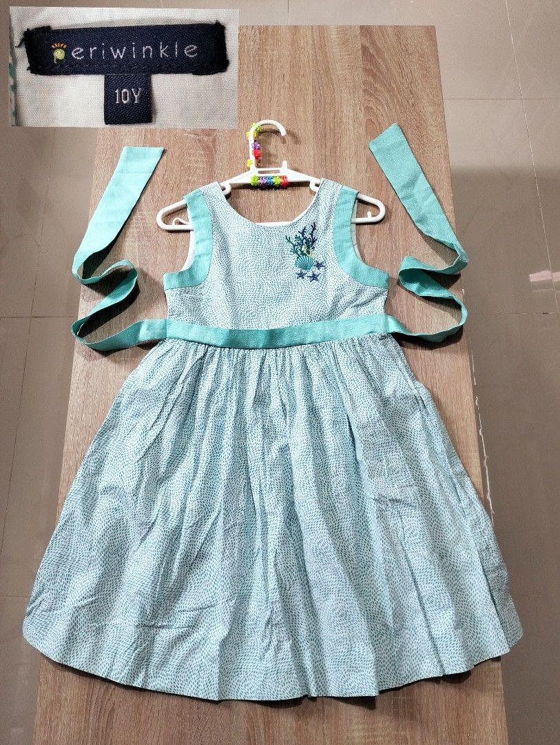 Periwinkle Turquoise Dress Size 10Y (Category: Babies & Kids Fashion) located in Angeles City. Submitted by heartfaveph. (Listing ID 1466104042, Image 1). Description: - Brand: Periwinkle - Size: 10 Years Old - Color: Vibrant turquoise - Design: Sleeveless with a flared skirt and matching back-tie waist sash - Details: Subtle textured patterned fabric with adorable embroidered sea shell and coral motif on the chest - Condition: Excellent - Perfec