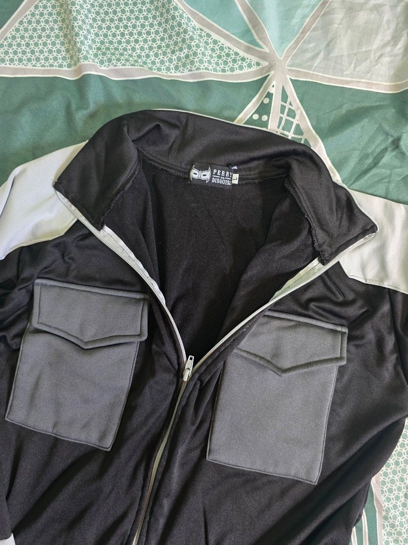 Perry Disguise Kaiju No. 8 Jacket (Category: Coats, Jackets and Outerwear) located in Malolos. Submitted by bueeens (Listing ID 1465988892, Image 3). Description: - Brand: Perry Disguise - Kaiju No. 8 Jacket - Color: Black and grey with light grey contrast panels - Size: L - Design: Full-zip with mock neck collar and segmented shoulder/sleeve detailing - Pockets: Two large front utility pockets with flap closures - slightly used - bought for 1.2k