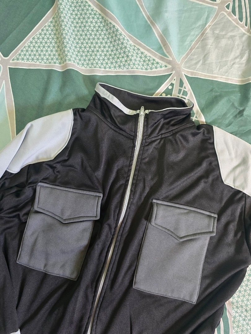 Perry Disguise Kaiju No. 8 Jacket (Category: Coats, Jackets and Outerwear) located in Malolos. Submitted by bueeens (Listing ID 1465988892, Image 2). Description: - Brand: Perry Disguise - Kaiju No. 8 Jacket - Color: Black and grey with light grey contrast panels - Size: L - Design: Full-zip with mock neck collar and segmented shoulder/sleeve detailing - Pockets: Two large front utility pockets with flap closures - slightly used - bought for 1.2k
