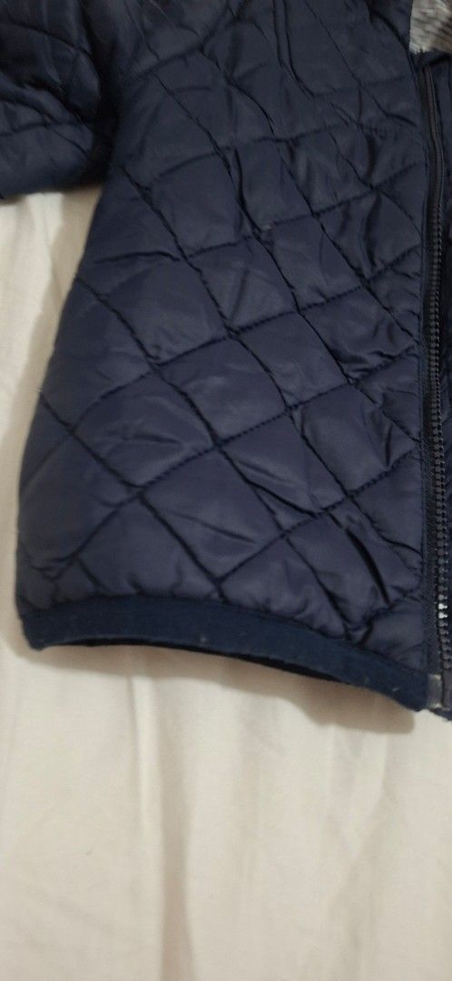 Petit Bateau Navy Quilted Puffer Hooded Jacket (Category: Babies & Kids Fashion) located in Taguig. Submitted by wolffangs (Listing ID 1466004987, Image 3). Description: - Brand: Petit Bateau (bought in Japan) - Size: 18months / 81cm - Color/Design: Navy with classic diamond outer pattern - Lining: Warm navy fleece inside the body - Hood: Attached hood with cute striped inner fabric - Closure: Full front zip.