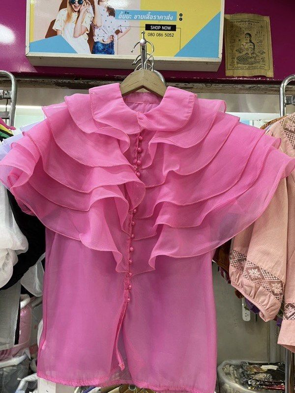 Pink Chiffon Ruffle Collar Blouse (Category: Blouses) located in Paranaque City. Submitted by jujudeclutterss (Listing ID 1466149048, Image 1). Description: - Color: Bright pink - Style: Sheer blouse with dramatic layered ruffles on shoulders and chest - Details: Classic collar neckline and front button closure with matching round buttons - Fabric: Lightweight with a straight hem - Condition: Great statement piece for dressing up.