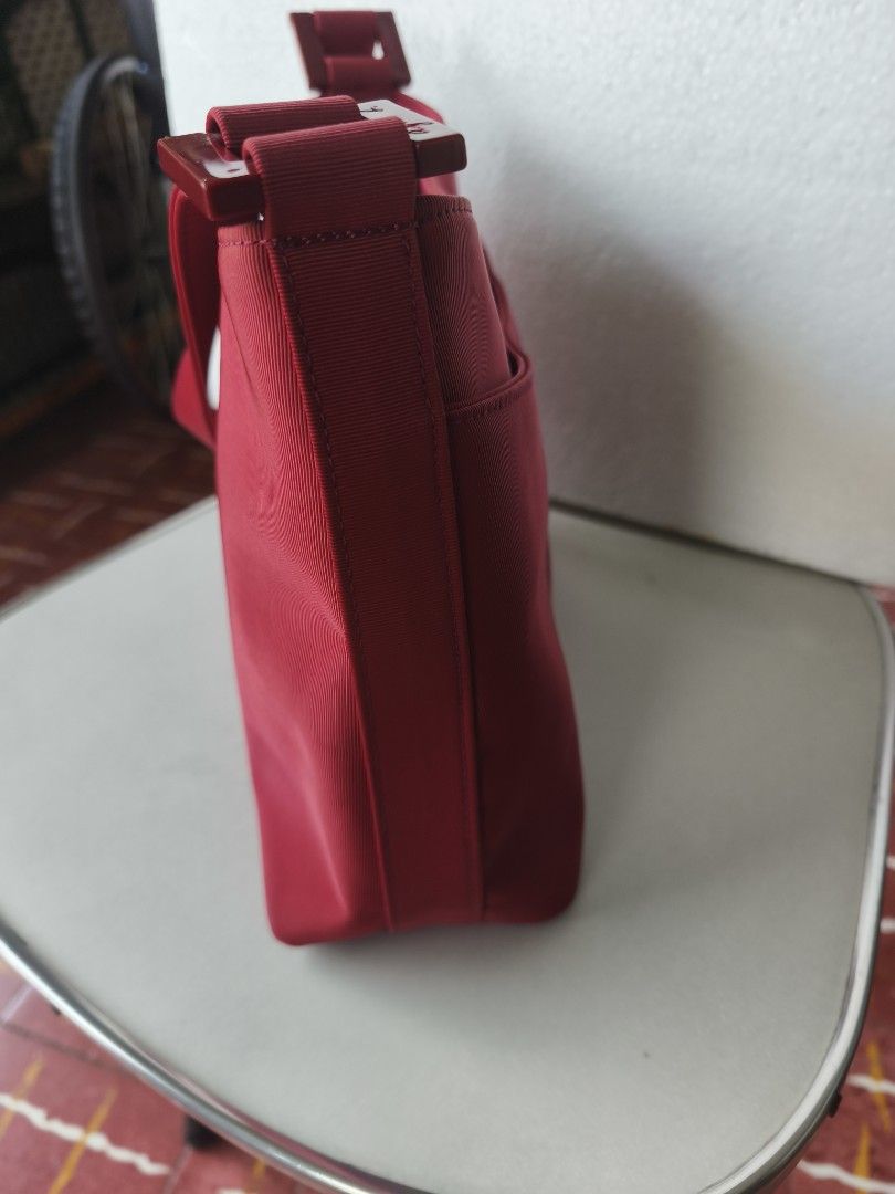 Pink Nylon Shoulder Bag with Magnetic Snap Closure (Category: Shoulder Bags) located in San Juan City. Submitted by vingabby (Listing ID 1465964543, Image 3). Description: - Color/Material: durable nylon maroon - Closure: Secure magnetic snap - Storage: Main compartment with an interior zippered pocket - Strap:shoulder strap - Interior: Clean lining featuring a visible brand logo patch.