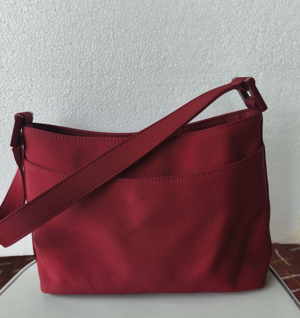 Pink Nylon Shoulder Bag with Magnetic Snap Closure (Category: Shoulder Bags) located in San Juan City. Submitted by vingabby (Listing ID 1465964543, Image 1). Description: - Color/Material: durable nylon maroon - Closure: Secure magnetic snap - Storage: Main compartment with an interior zippered pocket - Strap:shoulder strap - Interior: Clean lining featuring a visible brand logo patch.