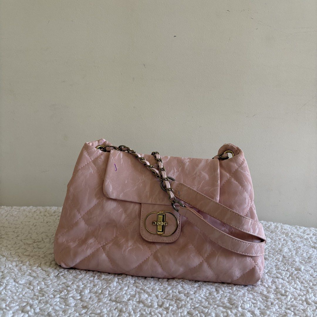 Pink quilted shoulder bag with chain strap (Category: Shoulder Bags) located in Calabanga. Submitted by vrncashane (Listing ID 1466114116, Image 1). Description: - Color: Pink with a soft crinkled finish - Design: Elegant quilted pattern throughout with antique brass-tone turn lock - Strap: Combined chain and leather strap design - Closure: Secure flap closure - Condition: Good, with a minor flaw (small purple ink mark near the upper flap corner)