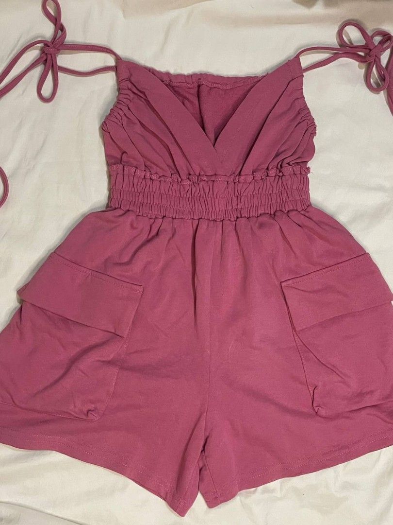 Pink Romper with Cargo Pockets and Tie Straps (Category: Rompers) located in Binan City. Submitted by declutterbyjwy (Listing ID 1466092847, Image 1). Description: shorts length: 14" - cotton fabric - need inner when worn - good as new, never used.