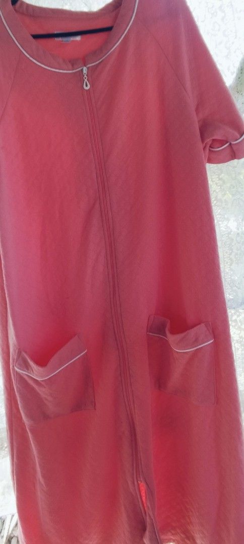 Pink zip robe with front pockets (Category: Undergarments & Loungewear) located in Alaminos. Submitted by dangpreloved01 (Listing ID 1465992722, Image 1). Description: Bright pink lounging robe, knee length style. Full front zipper closure makes it super easy to slip on and off. Short sleeves with white piping trim around the neckline, cuffs, and dual front patch pockets. Soft cotton-blend fabric, lightweight and very comfortable for relaxing at 