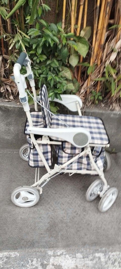 Plaid Rollator Walker with Seat and Storage Bag (Category: Wheelchairs) located in Manila. Submitted by benjie.benjie3 (Listing ID 1466081853, Image 3). Description: Folding Adult walker for seniors from Japan NO to COD NO swapping Estimate size H= 33 1/2 inches L= 25 Inches W=181/2 inches Capacity= single Material = metal , rubber, plastic Made in Japan 2nd hand with scratch No warranty If there's Damage or Issues they can be seen in the last pi