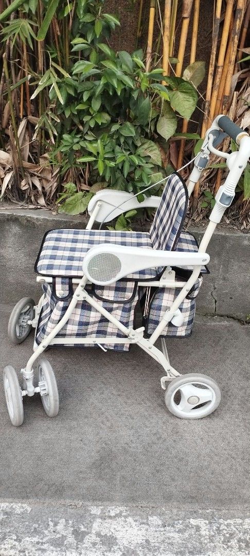 Plaid Rollator Walker with Seat and Storage Bag (Category: Wheelchairs) located in Manila. Submitted by benjie.benjie3 (Listing ID 1466081853, Image 2). Description: Folding Adult walker for seniors from Japan NO to COD NO swapping Estimate size H= 33 1/2 inches L= 25 Inches W=181/2 inches Capacity= single Material = metal , rubber, plastic Made in Japan 2nd hand with scratch No warranty If there's Damage or Issues they can be seen in the last pi