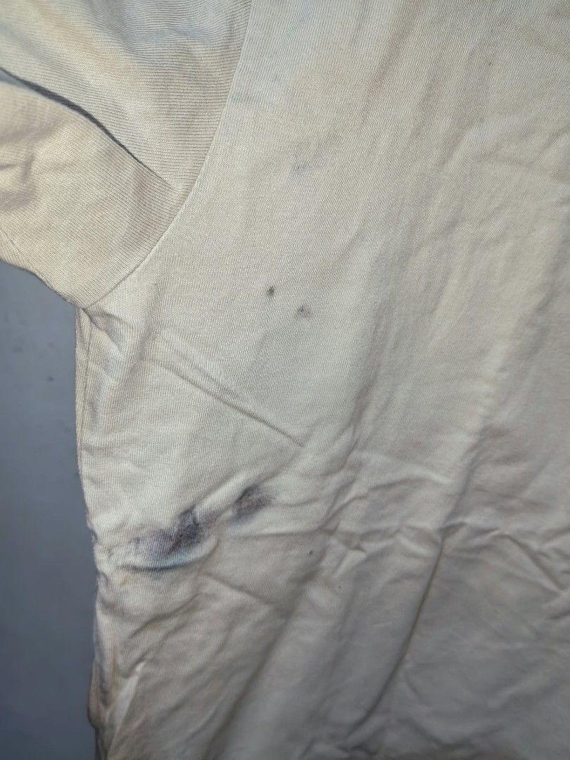 Plain Beige Short Sleeve T-Shirt (Category: Shirts) located in Quezon City. Submitted by jasalexiz (Listing ID 1466108083, Image 2). Description: - Color: Versatile beige - Fit: Regular fit, short sleeves - Material: 100% cotton with tagless inner collar for comfort - Condition: Pre-loved with general wear, wrinkling, and visible stains on the lower right side and collar area - Style: Casual everyday essential - Price reflects current condition -