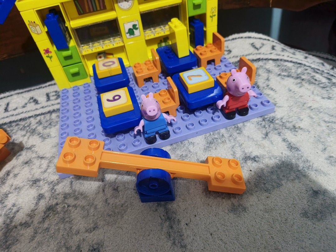 PlayBIG Bloxx Peppa Pig School Construction Set (Category: Kids Toys) located in Caloocan City. Submitted by mckysprelove (Listing ID 1465971889, Image 3). Description: - Authentic PlayBIG Bloxx Peppa Pig School construction set (Model 800057152) - Includes 87 pieces featuring a school building, desks, chairs, see-saw, blackboard stand, and number blocks - Comes with 2 adorable figures: Peppa and George - Designed with bright primary colors (yell