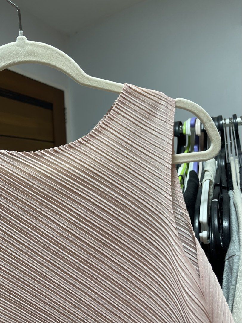 Pleated top (Category: Blouses) located in Tanza. Submitted by olaiya_ (Listing ID 1466005068, Image 2). Description: Asymmetrical hem pleated top V good condi, fits m-l comfortably Salmon light pink color No brand Tag pleats please issey miyake.