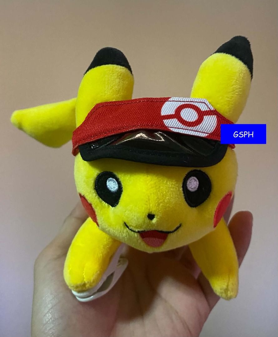 Pokémon Pikachu with Red Cap Clip Plush Toy (Category: Plushies & Soft Toys) located in Makati City. Submitted by goodiesstuff_ph_17119811 (Listing ID 1466099820, Image 1). Description: - Adorable Pikachu plush toy with a happy expression - Features a stylish red visor cap with a Pokéball logo - Equipped with a sturdy white plastic clip for easy hanging on bags or clothes - Made with soft, high-quality plush material.