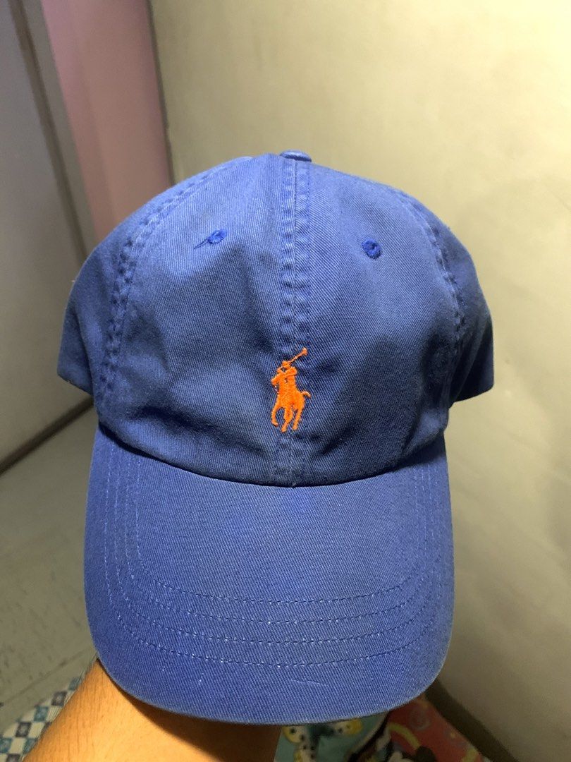 Polo Ralph Lauren Blue Cap with Orange Logo (Category: Caps & Hats) located in Manila. Submitted by jay_seller (Listing ID 1465963301, Image 1). Description: - Brand: Polo Ralph Lauren - Color: Royal blue with vibrant orange embroidered pony logo and 'POLO' back lettering - Material: 100% cotton - Size: Adjustable strapback with metal buckle closure - Origin: Made in Cambodia - Condition: Brand new / Excellent daily casual wear - Fast shipping an