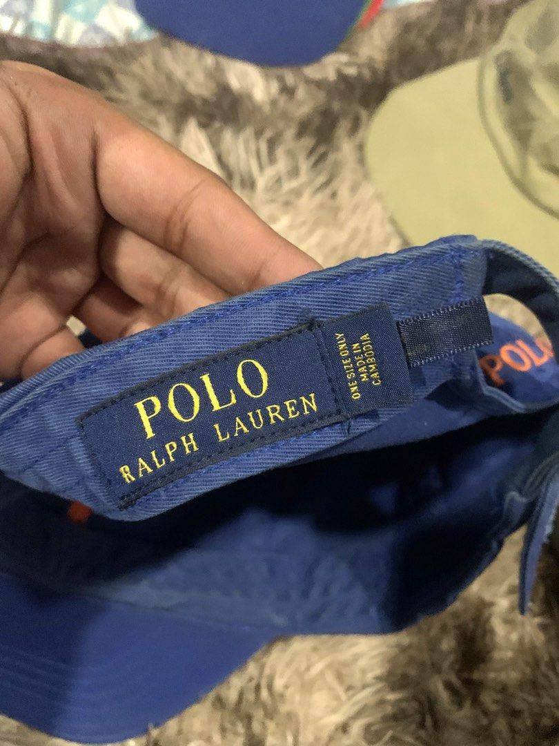 Polo Ralph Lauren Blue Cap with Orange Logo (Category: Caps & Hats) located in Manila. Submitted by jay_seller (Listing ID 1465963301, Image 3). Description: - Brand: Polo Ralph Lauren - Color: Royal blue with vibrant orange embroidered pony logo and 'POLO' back lettering - Material: 100% cotton - Size: Adjustable strapback with metal buckle closure - Origin: Made in Cambodia - Condition: Brand new / Excellent daily casual wear - Fast shipping an