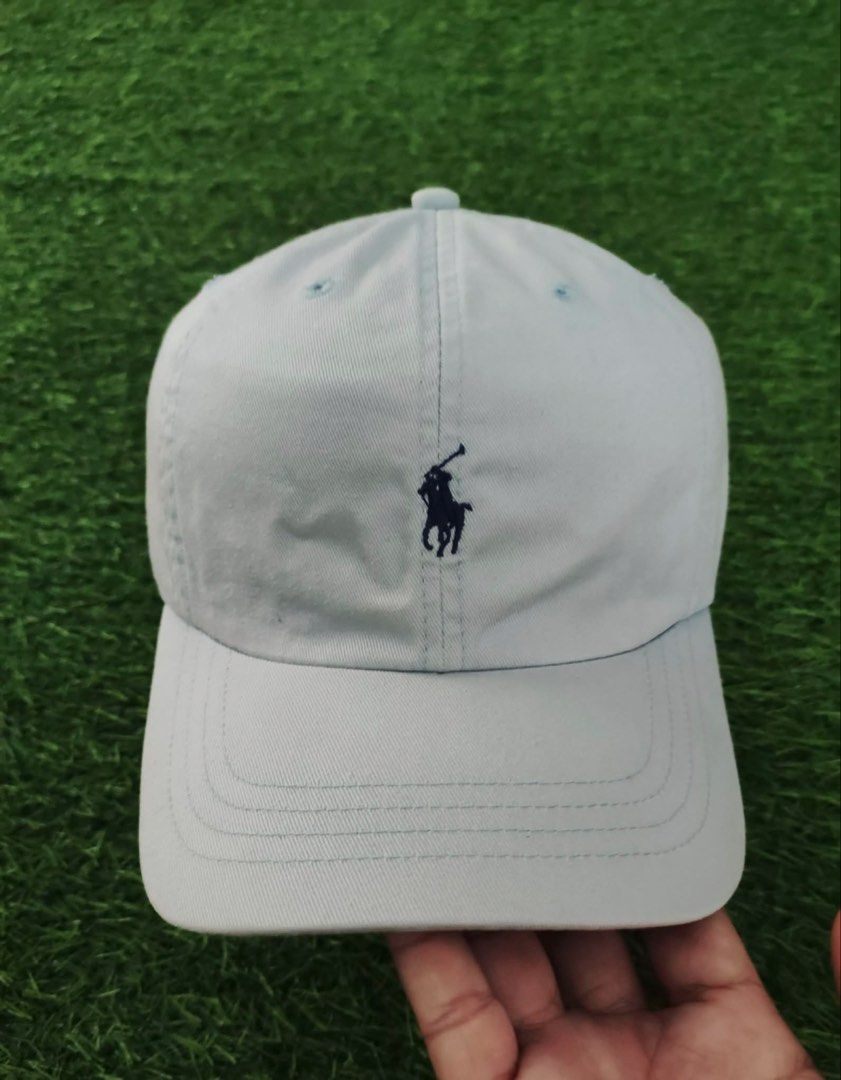 Polo Ralph Lauren Light Blue Baseball Cap (Category: Caps & Hats) located in Makati City. Submitted by rare_thrift_stuff (Listing ID 1465970630, Image 1). Description: - Brand: Polo Ralph Lauren - Color: Light blue with dark blue embroidered pony logo - Material: 100% cotton - Details: 'POLO' embroidered on the back, made in Taiwan tag inside - Closure: Adjustable brown leather strap with metal buckle - Condition: Excellent, stylish and ready to 