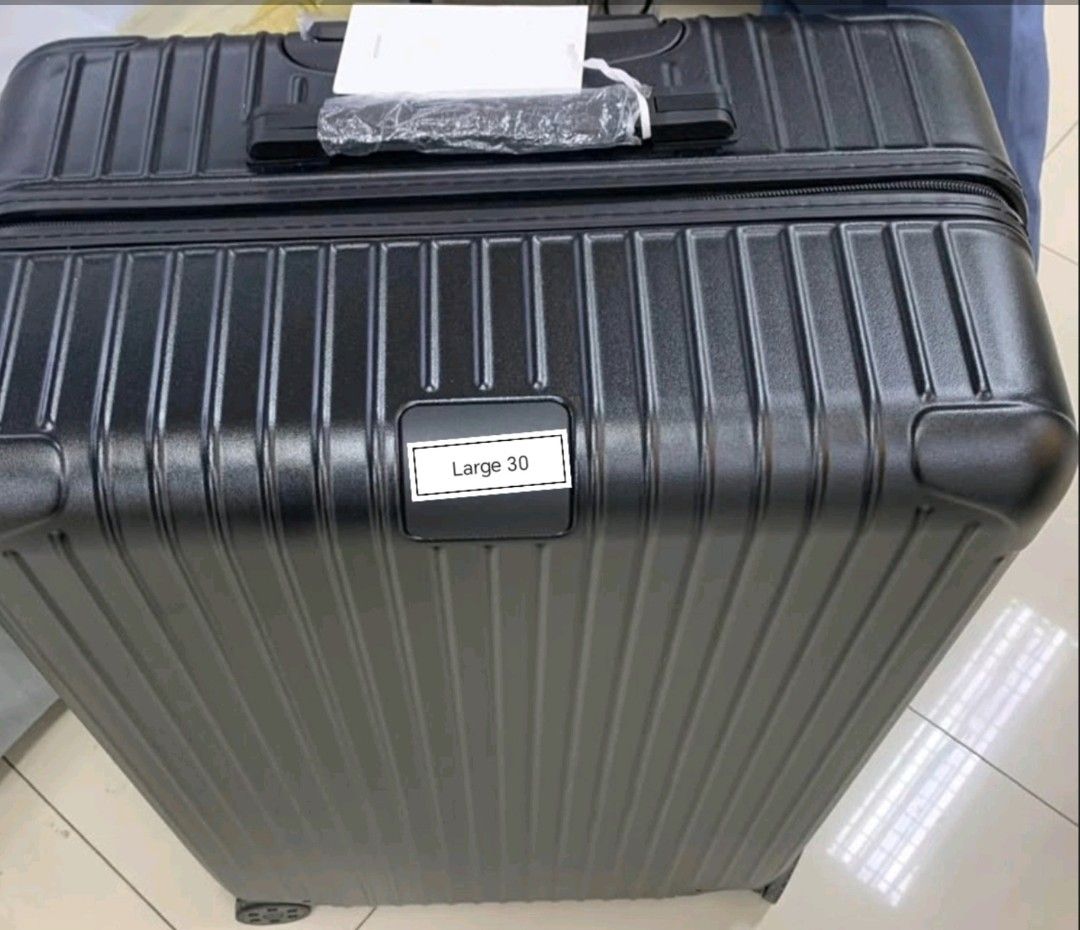 Polycarbonate luggage large 30 (Category: Luggage) located in Manila. Submitted by dh3nz1 (Listing ID 1466154484, Image 2). Description: - Size: Large 30-inch capacity, perfect for long trips - Color/Design: Sleek grey with a modern vertical ribbed exterior - Condition: Brand new with tag attached and protective plastic still on the handle - Mobility: 4 smooth-rolling wheels for effortless movement - Interior: Extra spacious to fit all your trave