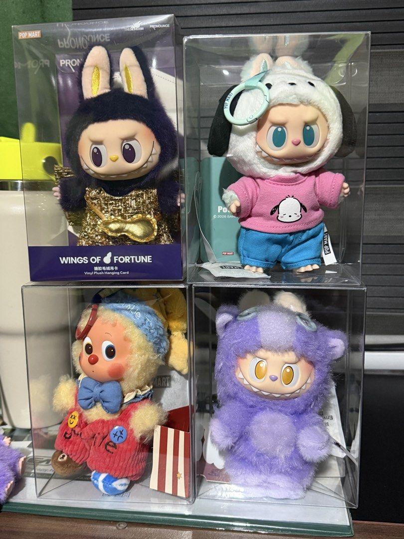 Pop Mart Labubu Vinyl Plush Doll Assorted Collection (Category: Plushies & Soft Toys) located in Bulacan. Submitted by elihoh (Listing ID 1466054181, Image 1). Description: - Authentic Pop Mart Labubu plush figures set of 4 - Includes: Wings of Fortune (gold/dark blue), Pochacco hooded version, Clown style (red overalls), and Solid Purple fluffy monster - Includes original individual display boxes - Extra protection: All figures stored safely in 