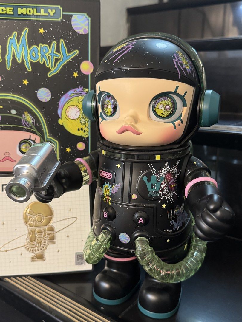 Pop Mart Mega Space Molly Rick and Morty 400% (Category: Designer & Blind Box Toys) located in Manila. Submitted by azyl.la (Listing ID 1466003609, Image 2). Description: - Item: Pop Mart Mega Space Molly 400% Rick and Morty Edition - Design: Black spacesuit with iconic show graphics and character eyes inside the helmet visor - Accessories: Includes the signature small silver accessory - Inclusions: Complete with original box and authenticity car