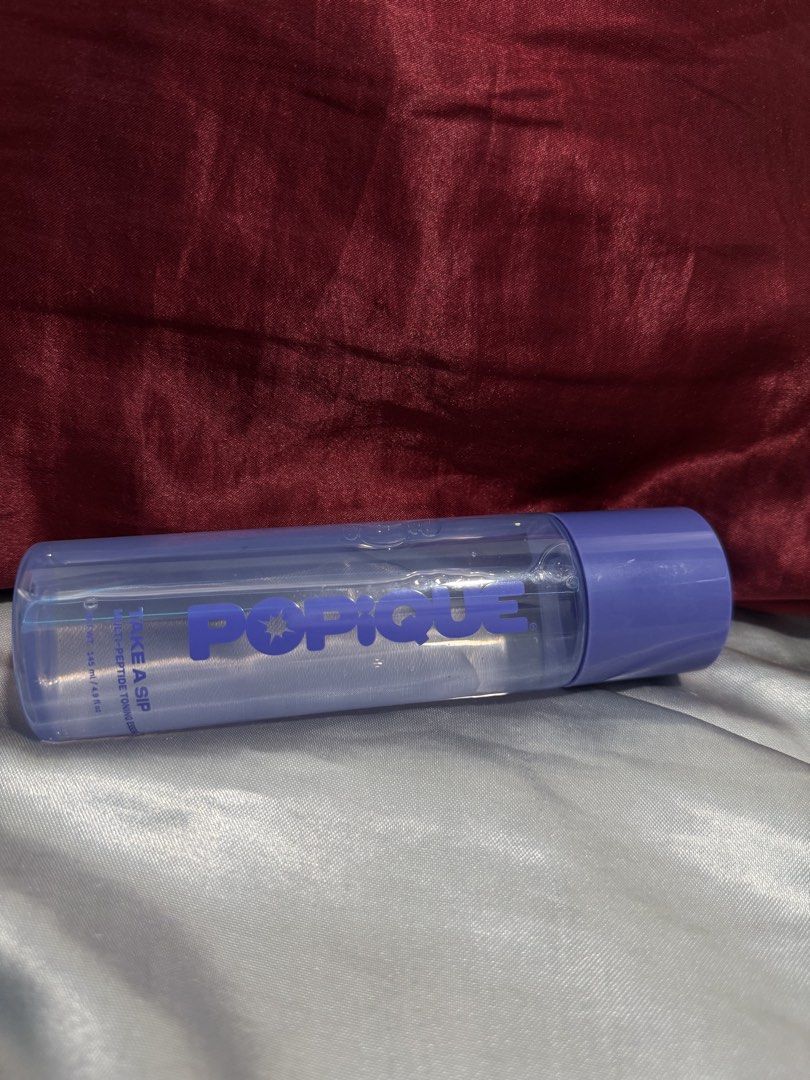 Popique Take A Sip Multi-Peptide Toning Essence 145ml (Category: Face Care) located in Manila. Submitted by 444sky (Listing ID 1466108902, Image 2). Description: - Brand: Popique - Product: Take A Sip Multi-Peptide Toning Essence - Size: 145 ml / 4.9 fl. oz. - Benefits: Provides deep hydration and strengthens the skin barrier - Packaging: Clear formula in a purple bottle with matching cap - Perfect addition to your daily skincare routine.