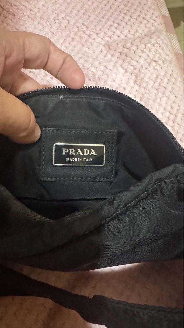 Prada Black Nylon Sling Bag (Category: Luxury Bags & Wallets) located in Davao. Submitted by triftedbagsforyou (Listing ID 1466052807, Image 2). Description: - Authentic Prada nylon crossbody and chest bag - Classic silver triangle logo plaque on front - Secure main compartment and zipped front pocket - Interior lined with Prada Made in Italy metal plaque and factory tag - Adjustable black strap with branded silver-tone metal buckle - Durable, ve