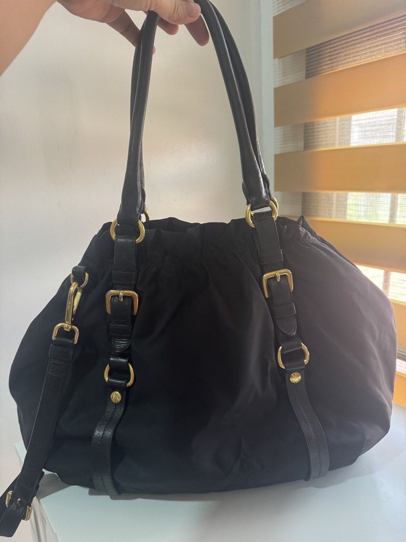 Authentic Prada Black Nylon Tote Bag with COA (Category: Luxury Bags & Wallets) located in Angeles City. Submitted by thala.1204.68 (Listing ID 1465968383, Image 3). Description: - Authentic Prada nylon tote bag in classic black/ comes with B101 Revue certificate for authenticity/100% original - comes with long strap - Elegant gold-tone hardware and metal Prada lettering logo - Double leather handles plus an adjustable shoulder strap for versatil